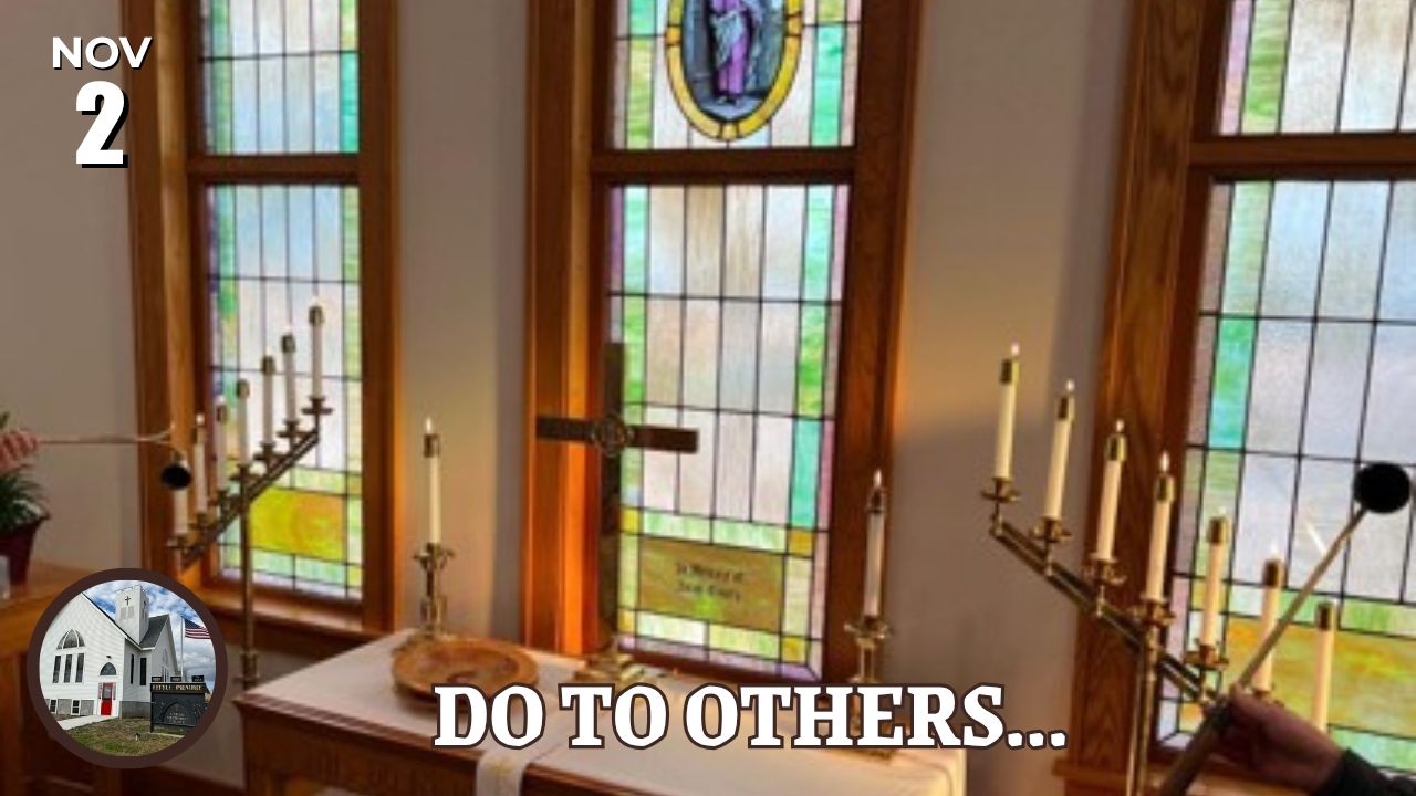 cross and candles on altar in front of windows