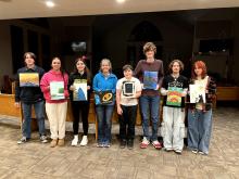 Youth holding artwork