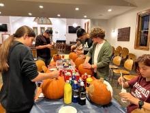 Youth carving pumpkins