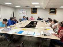Youth sitting at a table reading